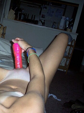 "Here's a fucking hot lady using a pink dick to get herself off while laying down."
