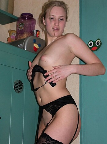 A scantily clad babe in black lace and fishnets laying bare.