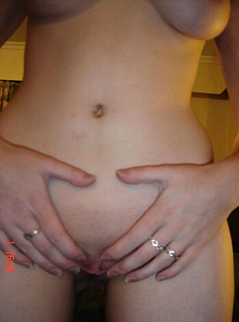 Vulgar Description: A naked chick is cupping her coochie.