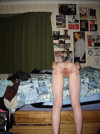 A dirty, disorganized-ass bedroom with some chick's booty in view.