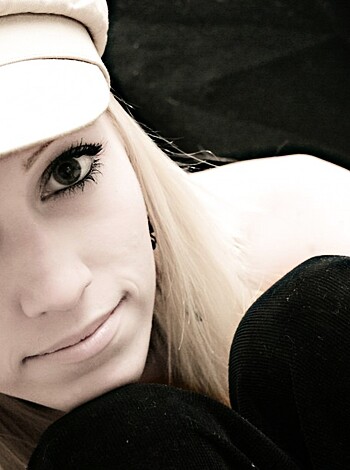 This chick is sporting a hat and got some locks flowin'.