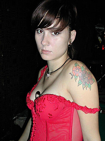 This chick's dressed up like some fuckin' hooker, sporting a tight-assed corset that looks all lacy and shit.