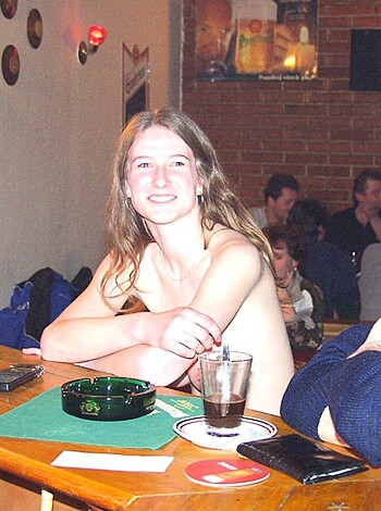 """
Fucking hot naked babe sittin' next to some dude with his cock out on a barstool.
"""