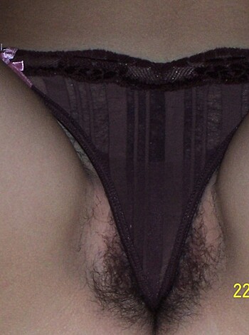 """
Close-up shot of a vagina through a red thong.
"""