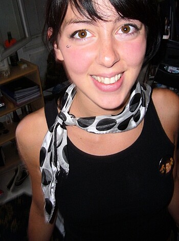 "Check out this babe, showing off her tits and smiling with her mouth open."
