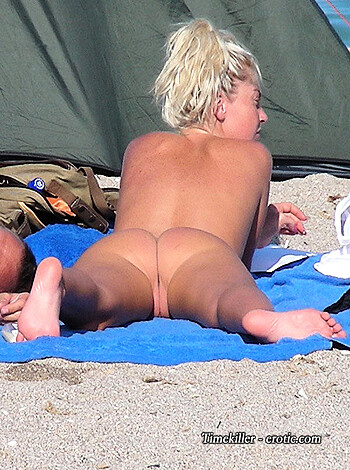 A naked broad lying on a fucking beach, getting some goddamn sun on her ass.