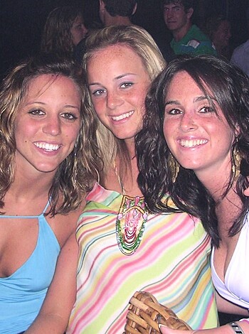 Two hot bitches, dressed up in skimpy lingerie, grinning from ear to ear.