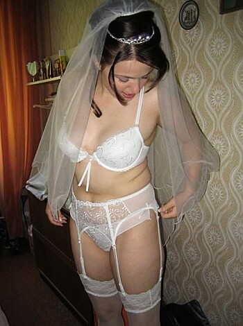 A chick dressed in panties and a fucking veil, posin' for the camera.