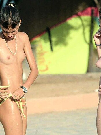 "Here's two tits and ass bitches on a sandy fuckin' shore, with one sporting a pussy bead and the other donning a motherfuckin' chain."