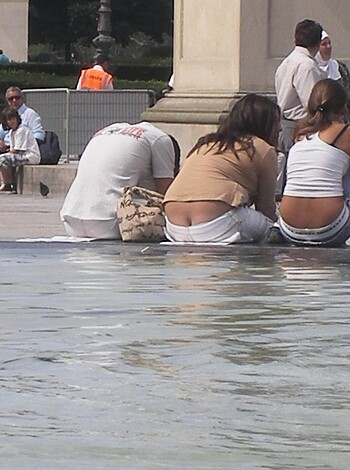 The blonde bimbo is lounging at the water fountain, her huge boobs spilling out of her skimpy bikini top.