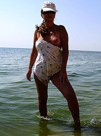 A hot chick in a bikini getting dicked down by the sea.
