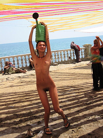 A naked chick is shaking her ass and fucking dance moves, while some creeps are staring at her from far away.