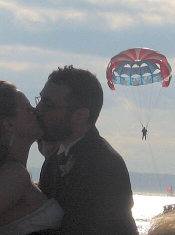 The newlyweds smash their juicy lips together while standing on the sandy shore, leaving a wet, sticky mess for all to see.