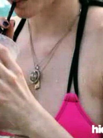 A fucking hot piece of ass is sipping on a goddamn green smoothie, her tits almost falling outta that skin-tight bikini top.