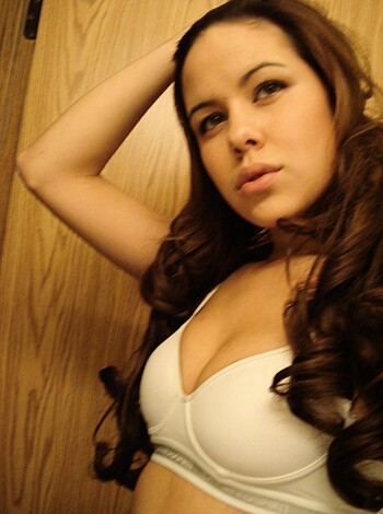 Here's the caption for the image: "A hot babe with some serious boobs, flaunting her cleavage in a sexy lingerie."