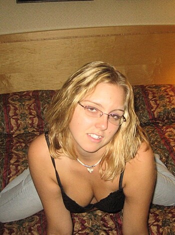 "Here's a busty broad with glasses fuckin' the mattress, sporting a sexy black brassiere."