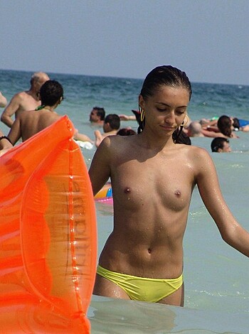 "Here's a fucking picture of some bare-chested broad taking a stroll on the shore with her ass hanging out for all to see. Goddamn, I'd tap that."