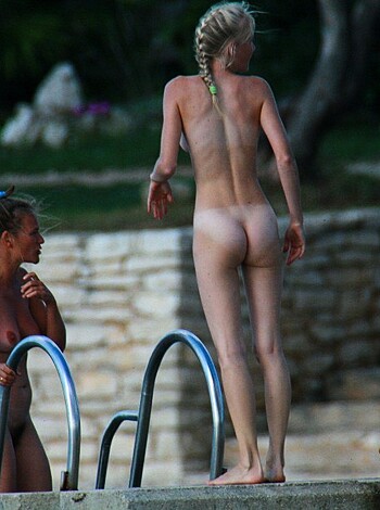 """
See two bitches chillin’ by the poolside with no clothes on, their racks all out and shit. Fuckin’ hot ass tits man, those bitches got nice ones. Damn, look at that wet pussy lips gettin’ soaked in the water while they fuckin’ chat it up. Yeah, this picture is definitely bringin’ me some pleasure, motherfucker!
""" 
(30 words)