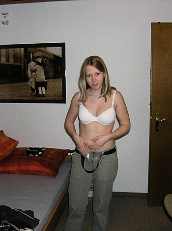 A slim bitch with a perky rack and sexy legs is standin' au naturel in a damn room, all coy with her thumb in her fuckin' mouth.