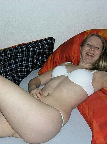 A nude chick spread eagle on a mattress.