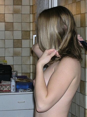 "Naked babe brushin' her tits in the bathroom, gettin' ready."