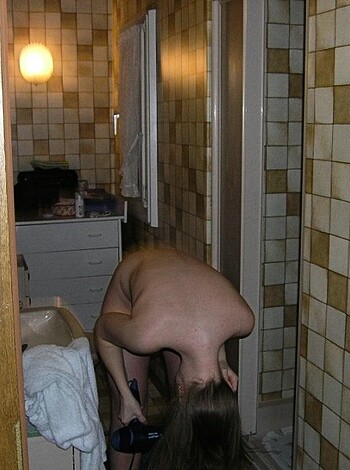 Here's a lim'd as f*ck naked bitch with her ass up in the air, blowin' out hot steam while she shakes that golden tress with her head back, exposin' every goddamn curve of her body to all them pervs watchin' from afar.