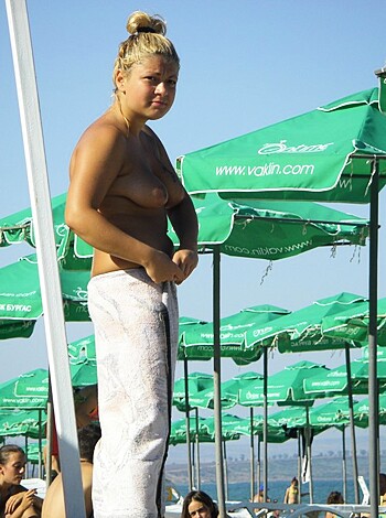 Vulgar description: Fucking hot babe with tits out, ass up, feet in the sand, dick-hardening the shit outta me.