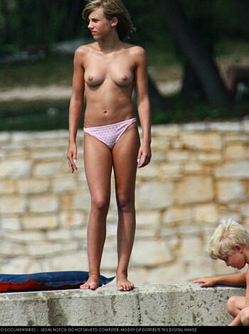 Here's a nude chick with a kid frolicking at a goddamn swimming hole, dude!