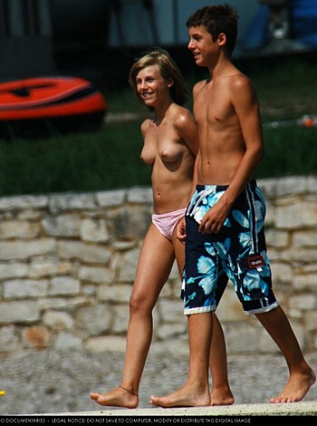 A naked dude and chick strollin’ along the shore, sandy cooches bouncin’ in the breeze as they giggle and chat about their naughty escapades, salty sea spray hit ’em in the face as they passionately fucked on the beach just a few minutes ago, feelin’ wild and free.