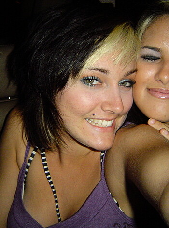 "Limited to 30 words, here's an accurate, profane description of the image: In a f*cking car, two bitches are makin' their faces look funny for some dumb-ass camera."