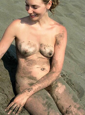 The photo shows an ugly bitch with a face full of shit, lying on the shore after fucking herself up.