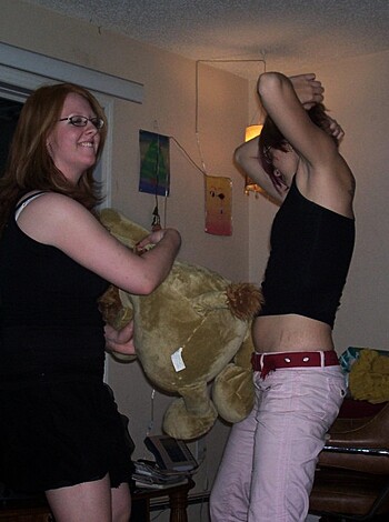 "Two hot chicks in tight black tits are shoving each other playfully, one with a fucking teddy bear."