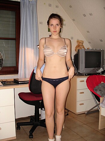 "Picture of hot babe wearing panties and hose in the bedroom. Vulgar description limited to 30 words."