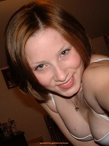 "Busty babe flashing her tits in lingerie for the camera."