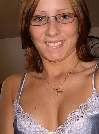 Here's a vulgar description of the image: 
This pic displays a slutty broad in her undies, with titties and ass hangin' out, flashing her gums at the fucking cam.