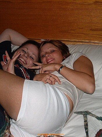 A couple of bare assed broads chillin' on a mattress.