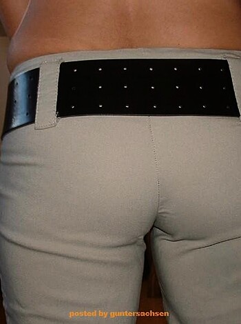 """
A tight ass wearing a belt and jeans.
"""