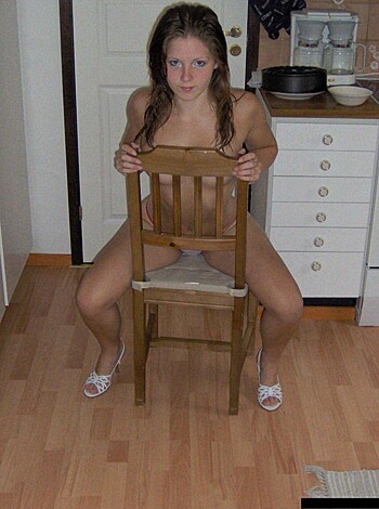 A goddamn naked bitch is sittin' on some fucking wooden stool like she don't got no shame, you feel me?