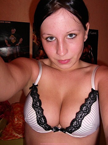 "Self-shot of hot brunette straddling a bed while wearing lacy undies, cameltoe evident."