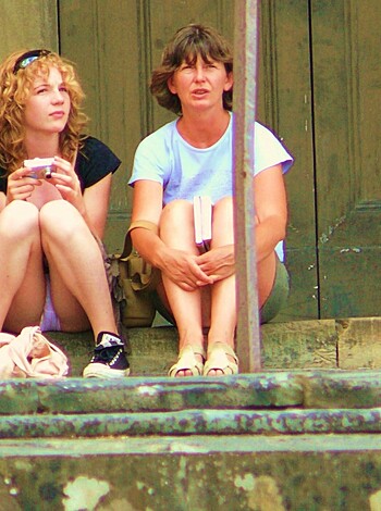 A young chick with a slutty babe taking a piss on some stairs in the hood.