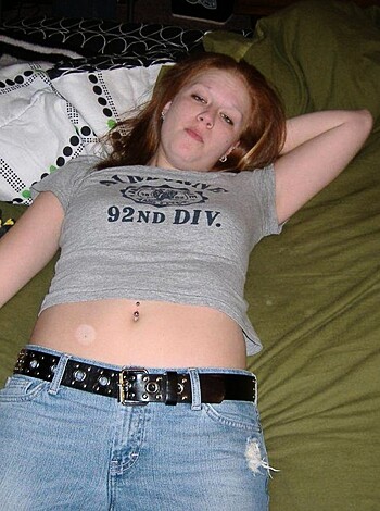 Here's a picture of some chick on her back, her legs spread open, wearing just a fucking belt around her tiny waist, showing off that smooth skin between her tits. You can see the fucking strap of her thong and her tight little asshole poking out from beneath her.