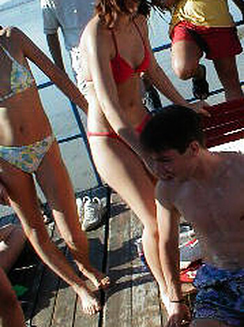 Two people fucking with an audience watching them go down on each other's faces in the park while their friends look on and jerk off to it.