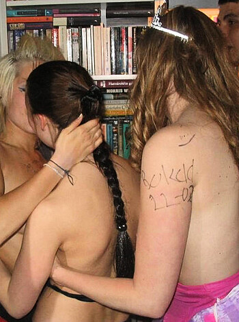 Here are three naked chicks going at it with each other, making out like crazy on the shelves while fucking reading material lays around them.