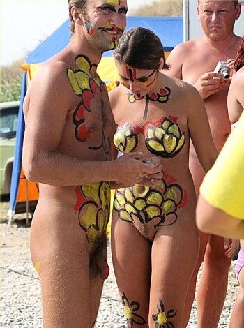 "Fucking naked couple with fucking painted bodies surrounded by other fucking nude people."