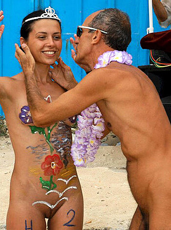 A fucking couple goofing off with their dicks out on the sand while getting dicked down by other half-naked folks at some goddamn beach party.