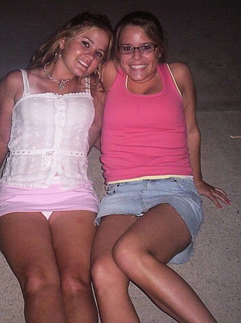 Two slutty bitches with tight asses lying on the fucking ground, smiling like retarded cunts, all up in each others grilles, taking a shitty pic in some dumbass location.