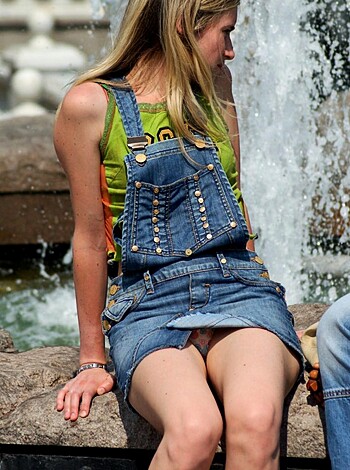 Bitch sits on fucking water-spouting thing in denim outfit, while showing off her dumbass legs.