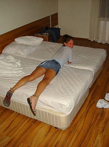 A chick spread eagle on her rumpled sheets, nude as the day she was born.