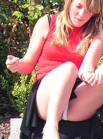 A chick's naked legs spread open with her painted toenails pointing up at the sky.