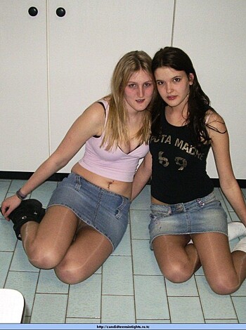 Rewritten Caption - Two bitches sittin' ass-to-ass on the ground, legs crossed like some kinda yoga shit.
